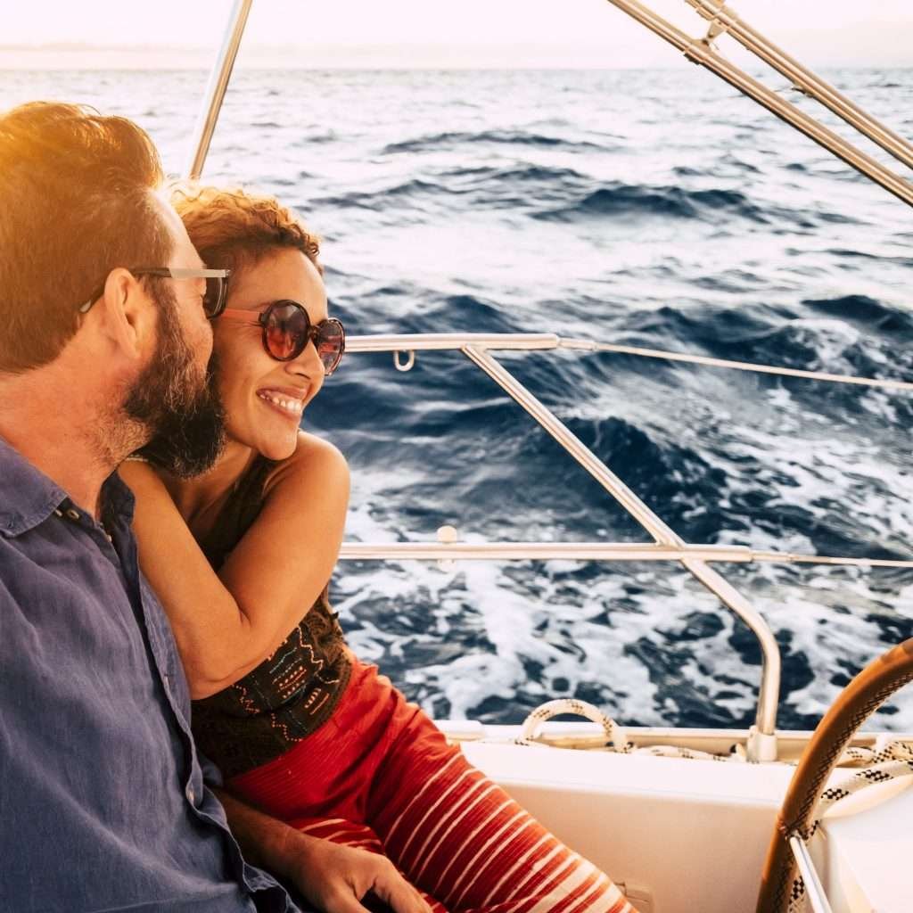 Couple in happiness enjoy a sail tour in yacht