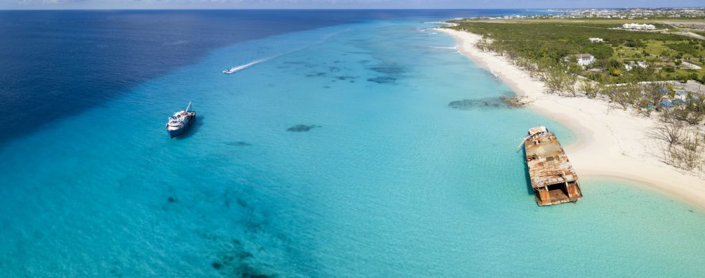 Aerial panorama of Grand Turk with clear water, boats, and shipw
