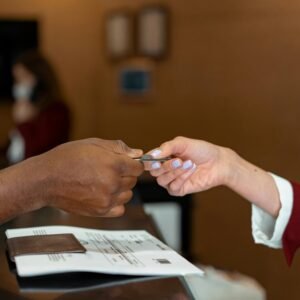 Man handing a credit card to a hotel receptionist